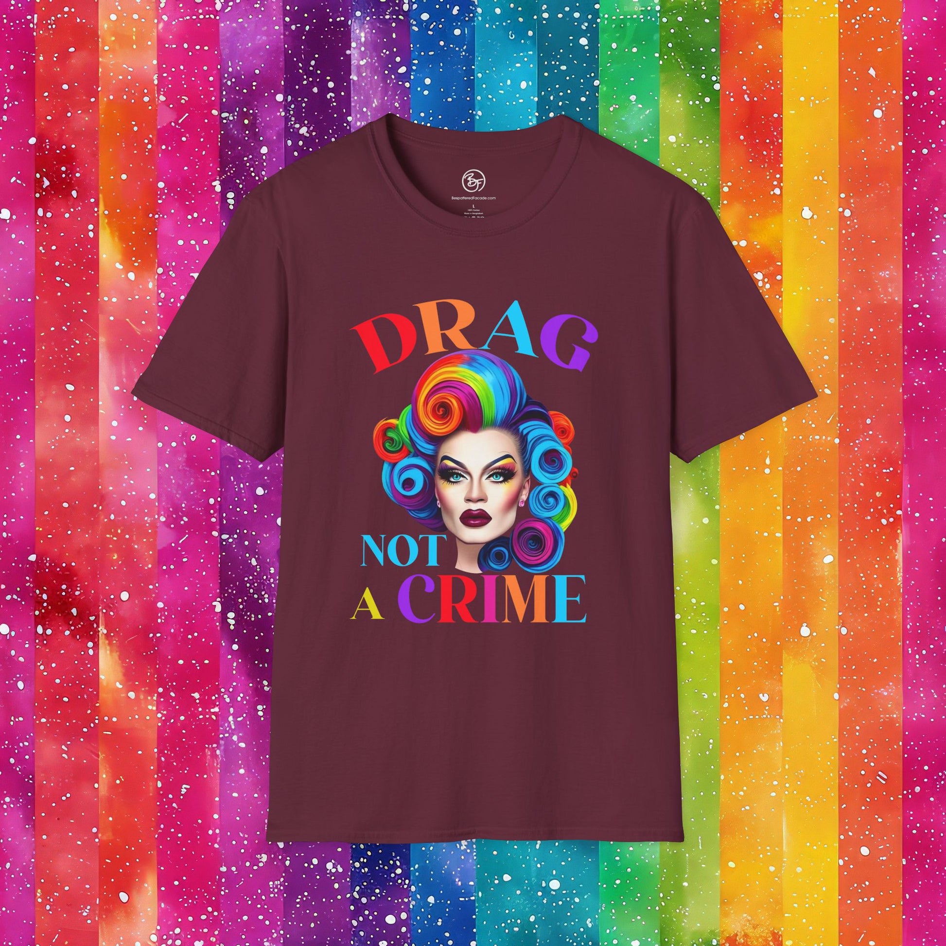 Maroon t-shirt with 'Drag Not A Crime' graphic on a colorful striped background