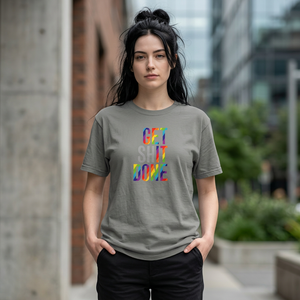 Woman wearing a gray t-shirt with colorful text in an urban setting