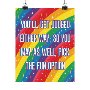 A colorful poster print with diagonal rainbow stripes and white text reading, 'YOU'LL GET JUDGED EITHER WAY, SO YOU MAY AS WELL PICK THE FUN OPTION,' shown hanging from two black binder clips against a light gray background.