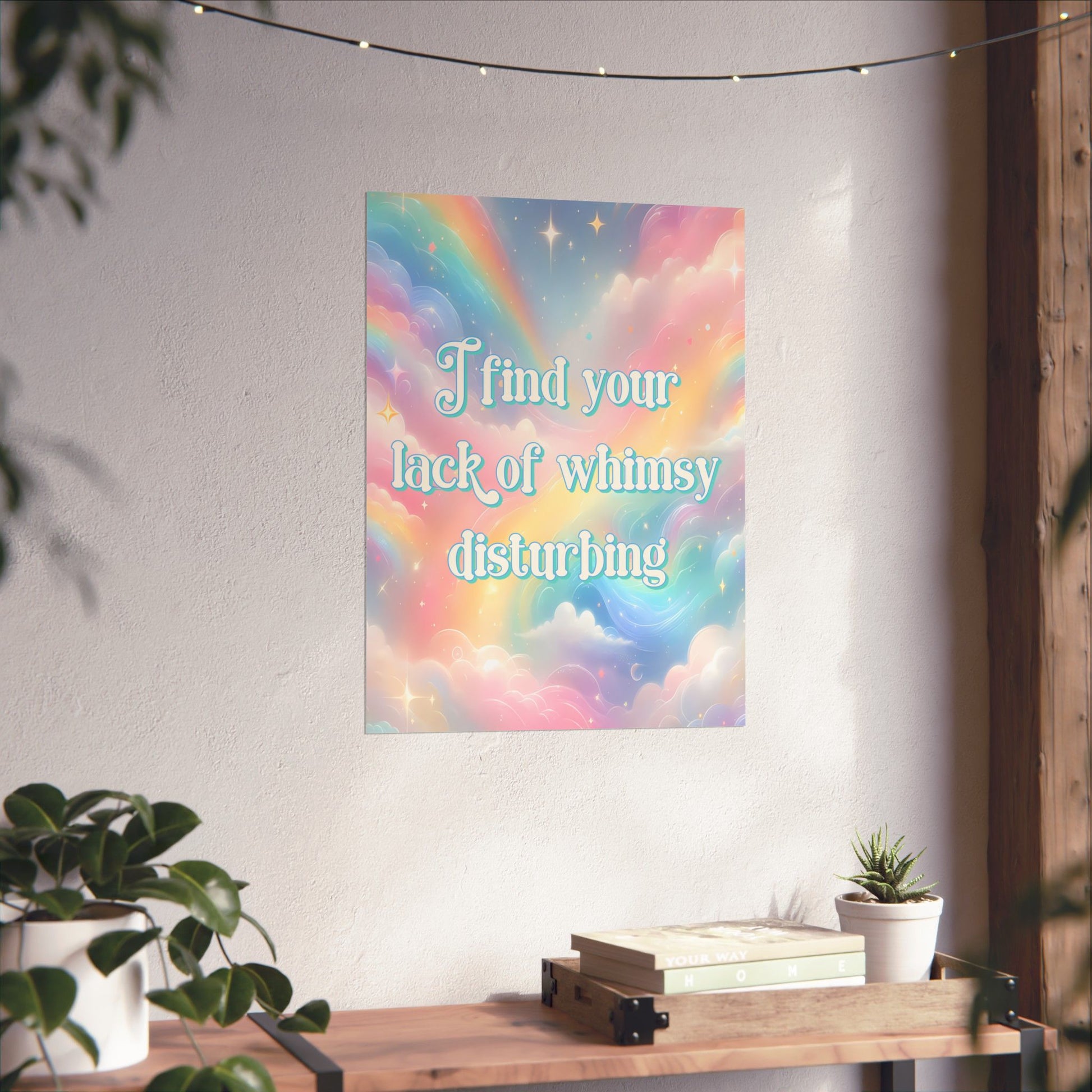 A pastel rainbow and cloud art print with the text 'I find your lack of whiny disturbing' displayed on a wall above a wooden console table with books and a small plant.