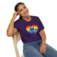 Person wearing a purple t-shirt with a rainbow heart and alien design, sitting on a white background.