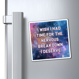 A rectangular refrigerator magnet with a colorful galaxy print and the text 'I WISH I HAD TIME FOR THE NERVOUS BREAKDOWN I DESERVE' in white, shown attached to a silver stainless steel refrigerator door next to the handle.