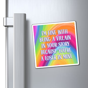 A square refrigerator magnet with a colorful rainbow gradient background and white text that reads, 'I'M FINE WITH BEING A VILLAIN IN YOUR STORY BECAUSE YOU'RE A LOSER IN MINE,' shown attached to a silver stainless steel refrigerator door next to the handle.