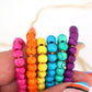 Bead Bundle: 7mm Rondelle Handmade Bone Beads, Carved Target, Bright Rainbow, 6 Strands